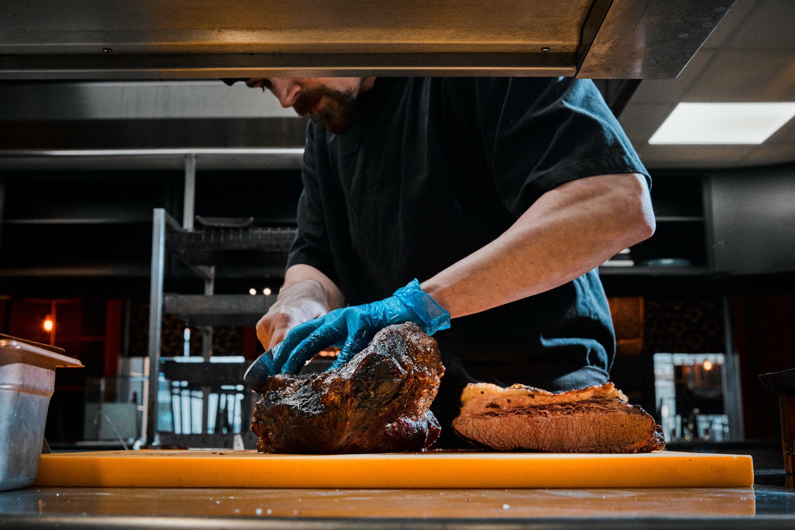 Chef slicing meat at Flesh & Buns Covent Garden